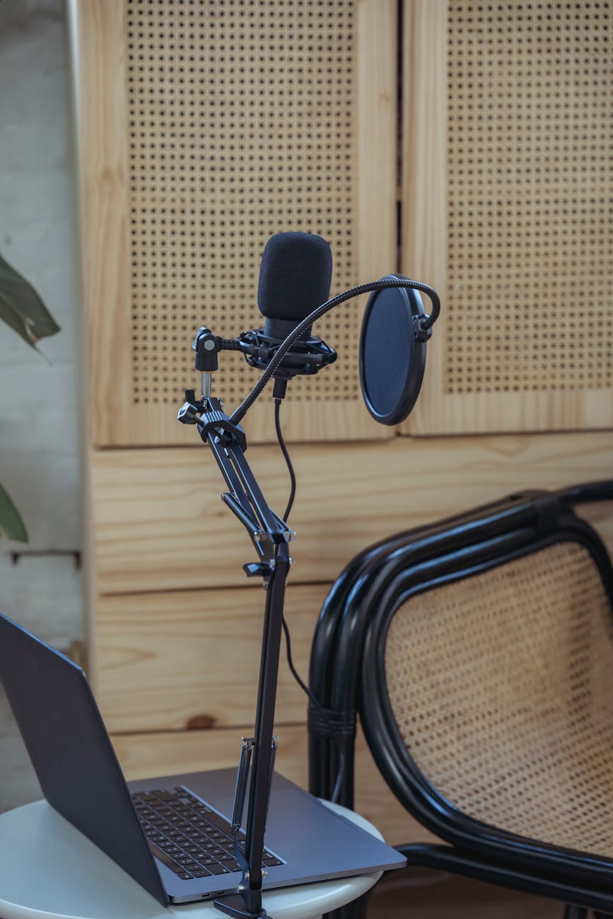 laptop and microphone placed near chair in radio studio